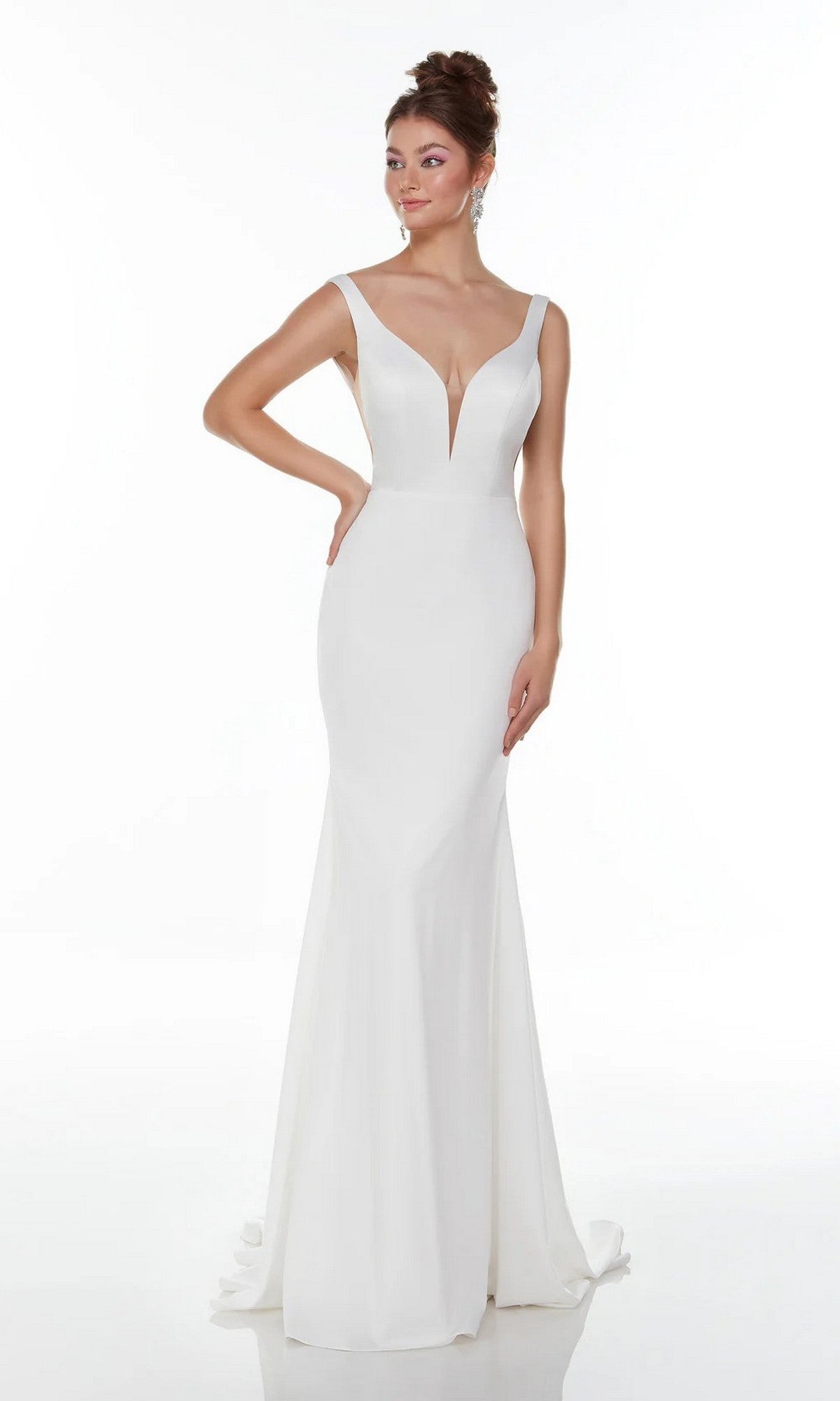 A modern bride poses against a plain white background, wearing the Alyce 7052 Long White Dress—a sleeveless gown with a deep V-neckline and floor-length skirt that radiates elegance and sophistication.